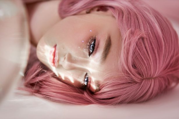 Portrait of a sexy young woman with pink hair. Perfect hairstyle and hair coloring. Girl
